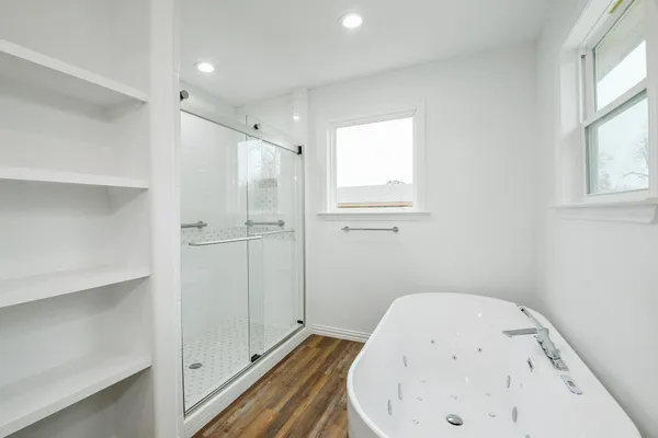 a bathroom with a bathtub and shower