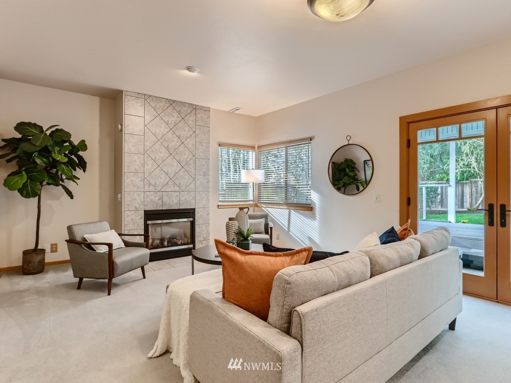 23630 3rd Place West Bothell, WA 98021 - Photo 14 of 28 a living room with furniture a fireplace and a large window