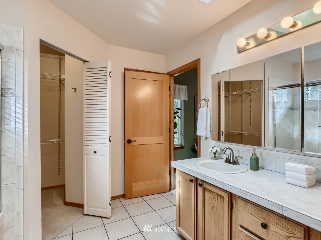 23630 3rd Place West Bothell, WA 98021 - Photo 20 of 28 a bathroom with a granite countertop sink and a mirror