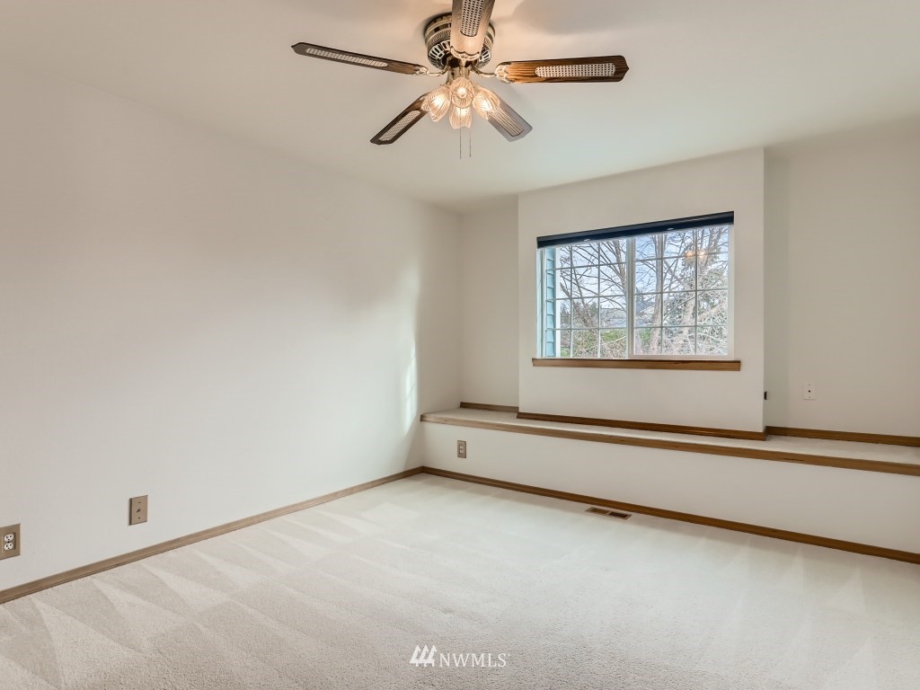 23630 3rd Place West Bothell, WA 98021 - Photo 21 of 28 an empty room with chandelier fan and windows