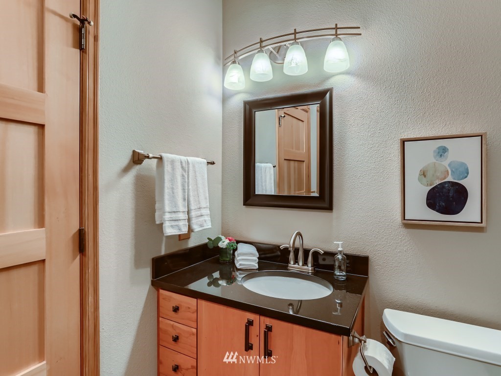 23630 3rd Place West Bothell, WA 98021 - Photo 25 of 28 a bathroom with a granite countertop sink a toilet and mirror