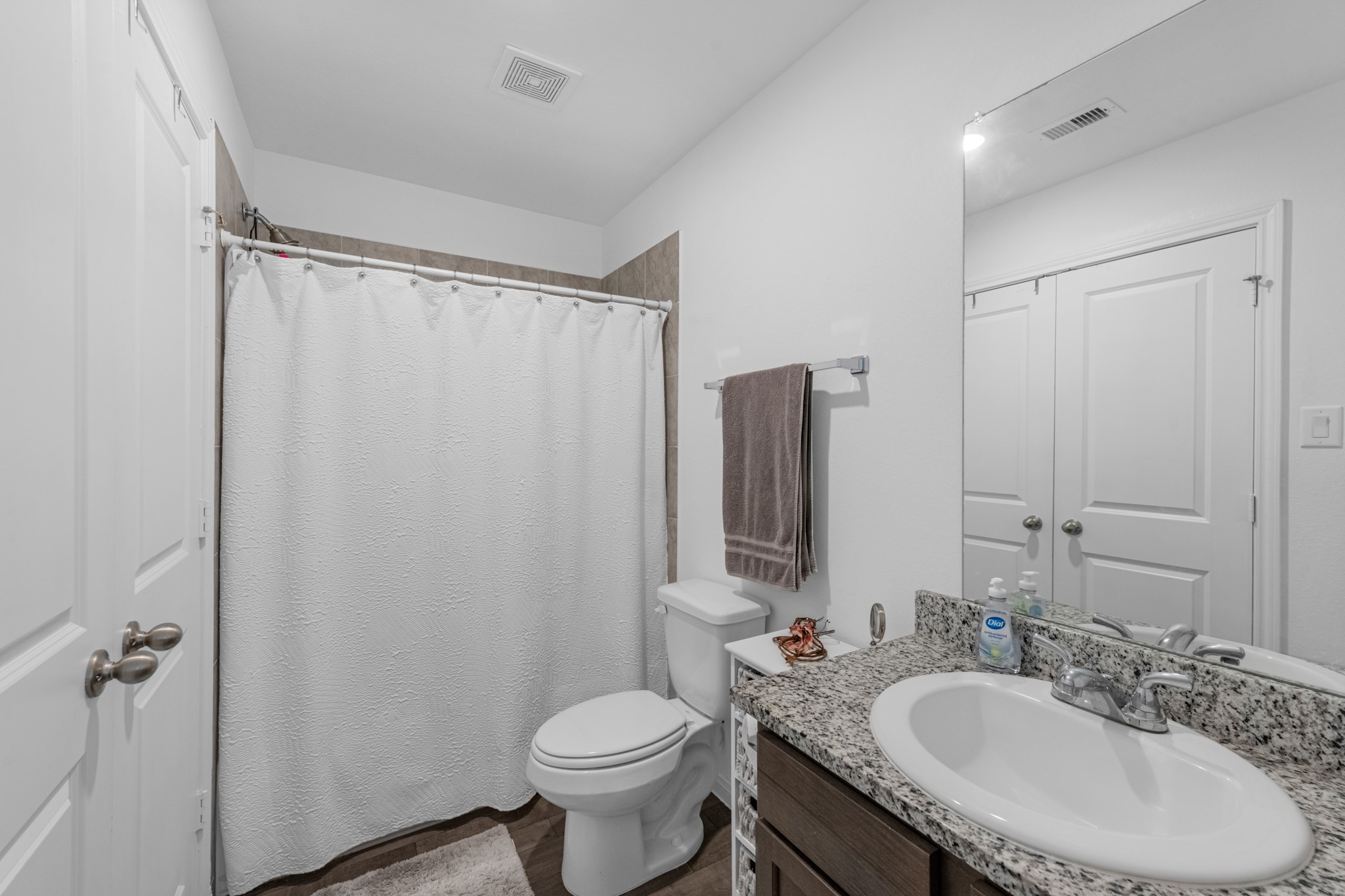 16511 Colleen Place Conroe, TX 77306 - Photo 13 of 17 a bathroom with a granite countertop sink toilet and shower