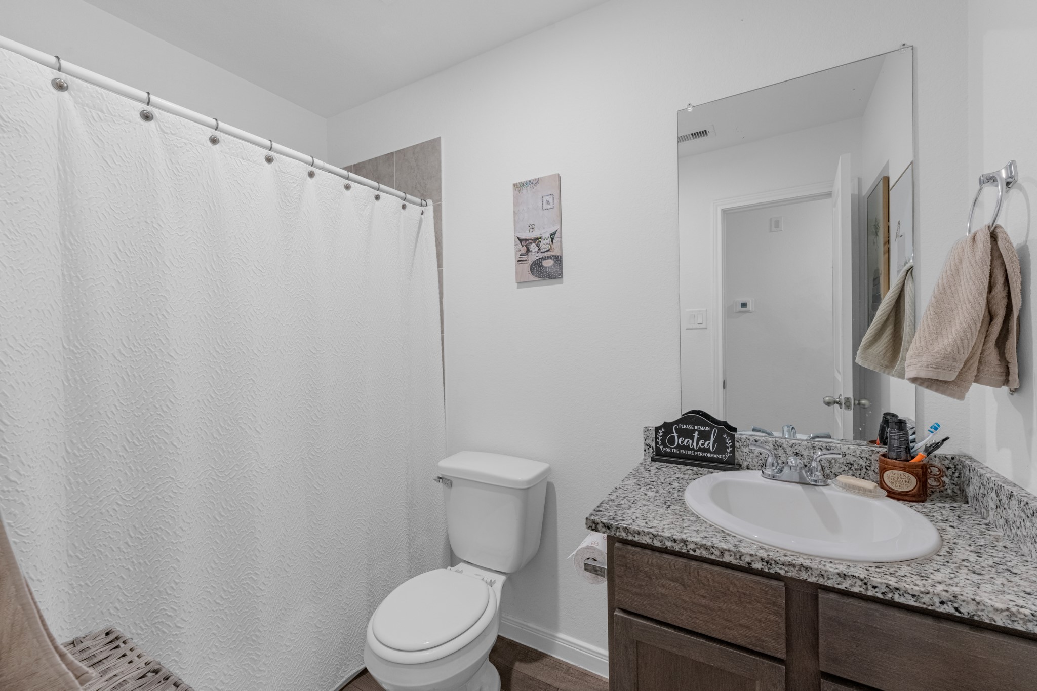 16511 Colleen Place Conroe, TX 77306 - Photo 16 of 17 a bathroom with a granite countertop sink toilet and a mirror