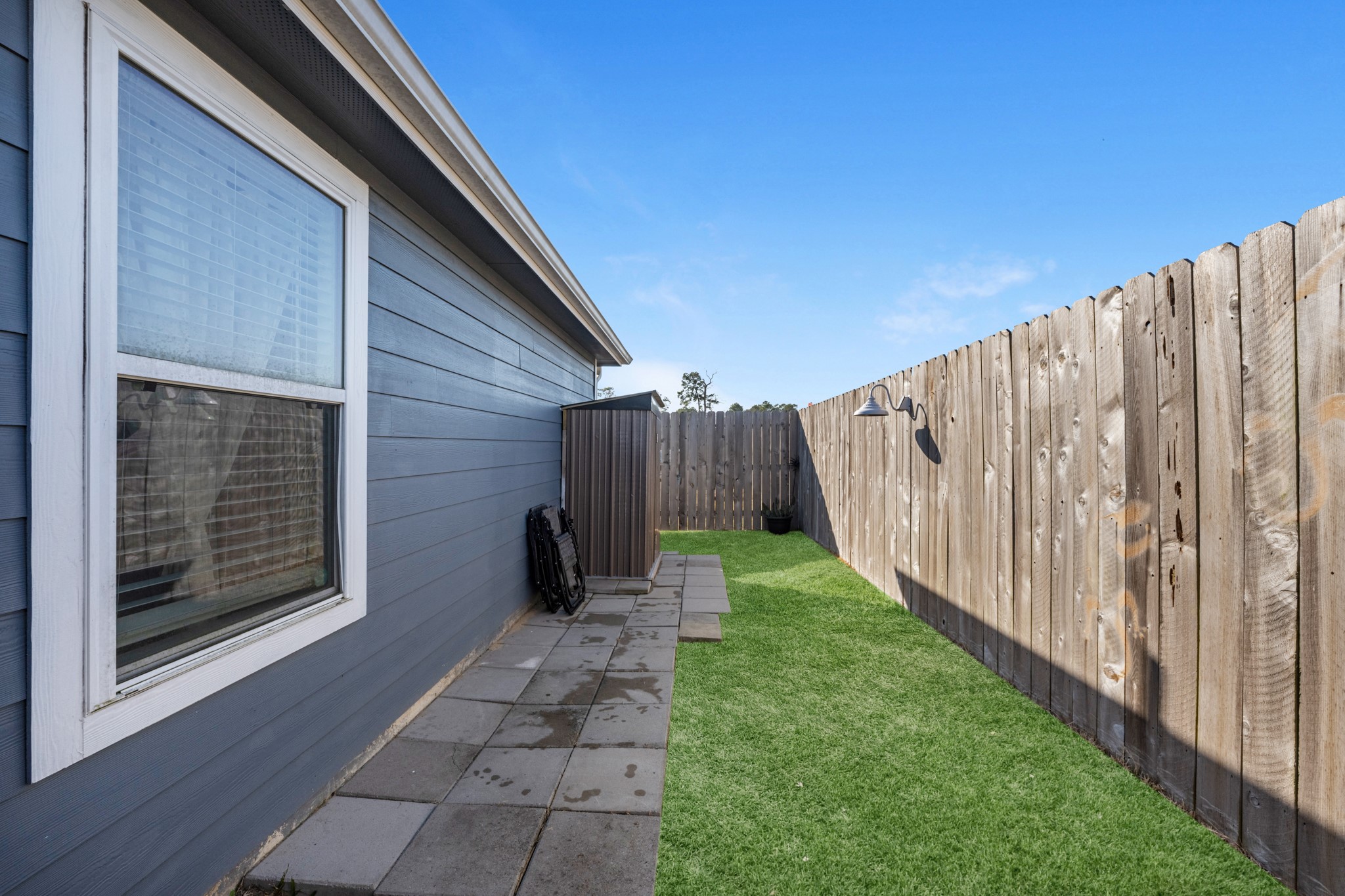16511 Colleen Place Conroe, TX 77306 - Photo 17 of 17 a view of a backyard with wooden fence