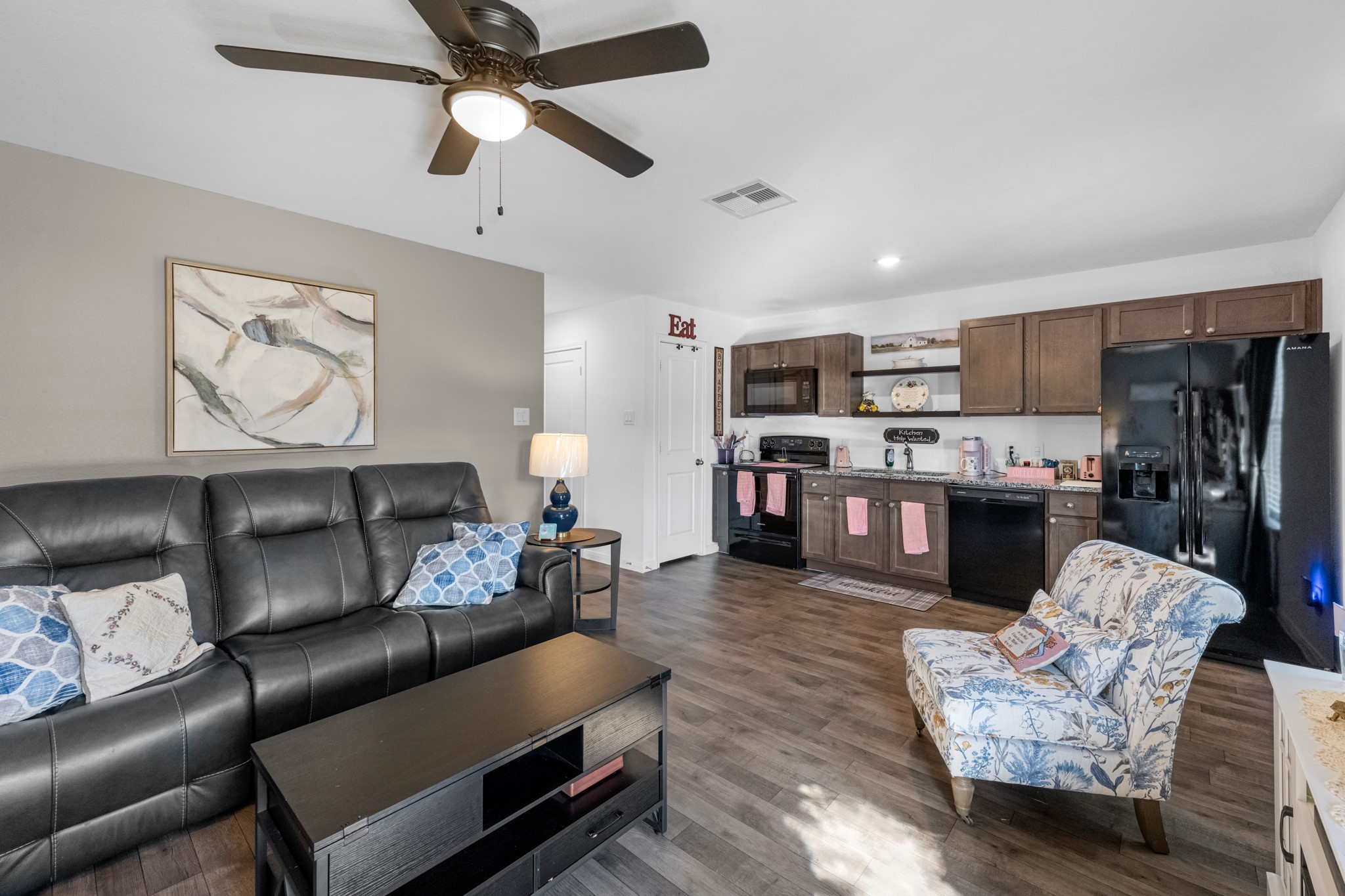 16511 Colleen Place Conroe, TX 77306 - Photo 8 of 17 a living room with furniture kitchen view and a chandelier