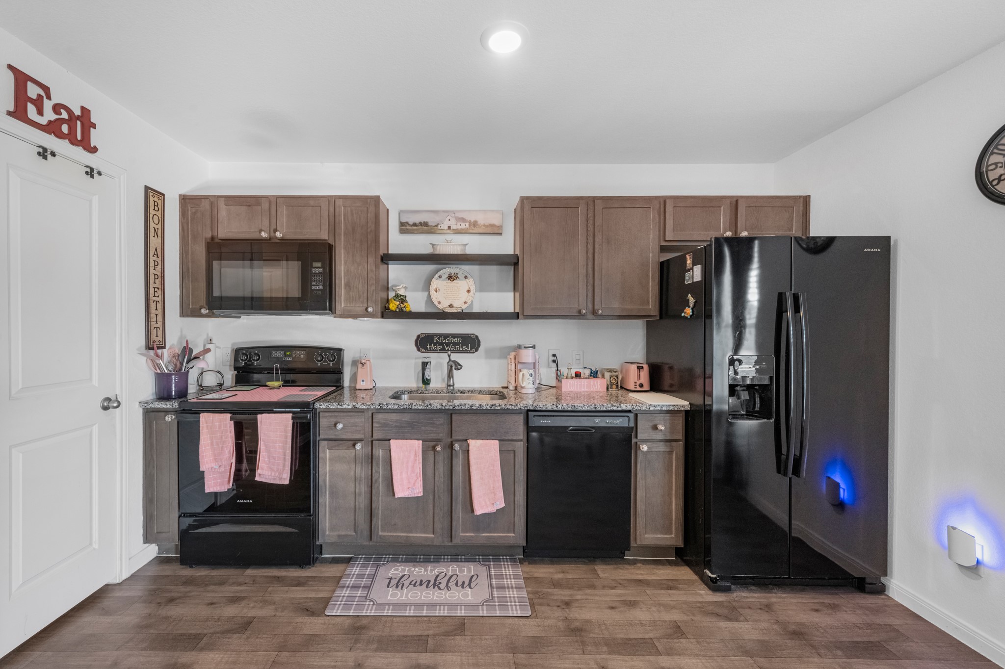 16511 Colleen Place Conroe, TX 77306 - Photo 10 of 17 a kitchen with stainless steel appliances granite countertop a refrigerator and a stove top oven