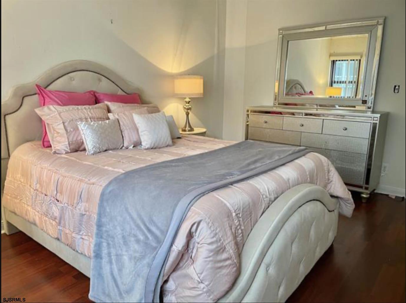 3101 Boardwalk, Unit 12102 Atlantic City, NJ 08401 - Photo 12 of 27 a bedroom with a bed and a mirror on dresser