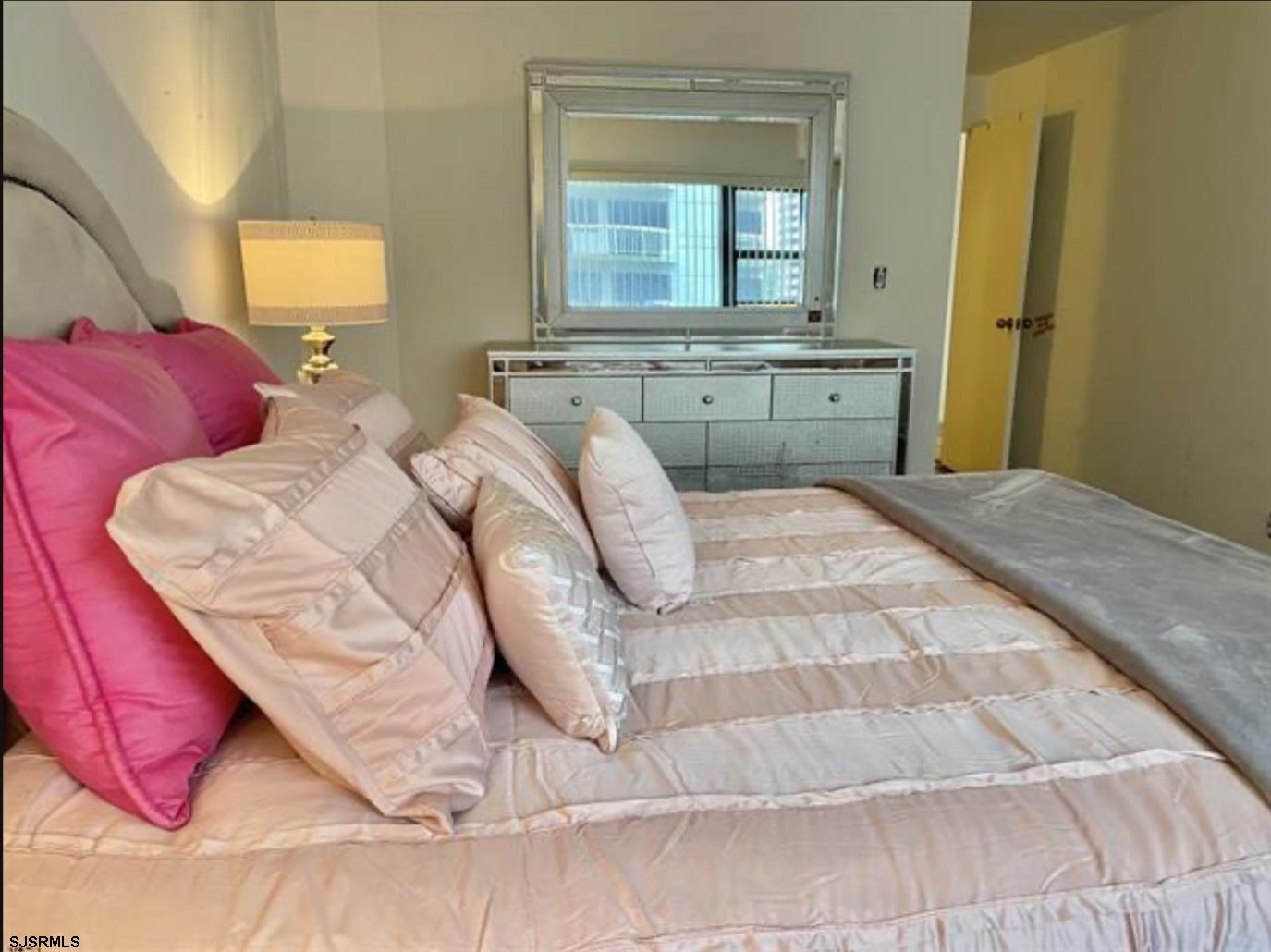 3101 Boardwalk, Unit 12102 Atlantic City, NJ 08401 - Photo 13 of 27 a bedroom with a bed and window