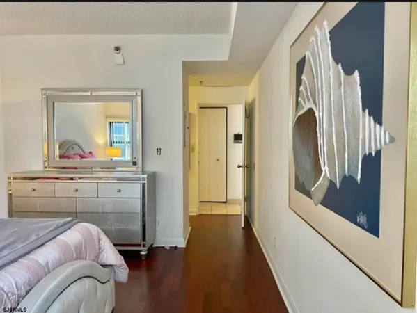 a bedroom with a bed and a mirror