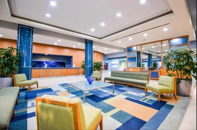 a living room with furniture a rug and a potted plant