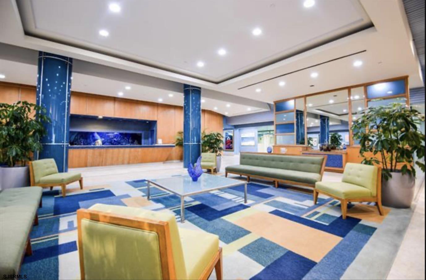 3101 Boardwalk, Unit 12102 Atlantic City, NJ 08401 - Photo 18 of 27 a living room with furniture a rug and a potted plant
