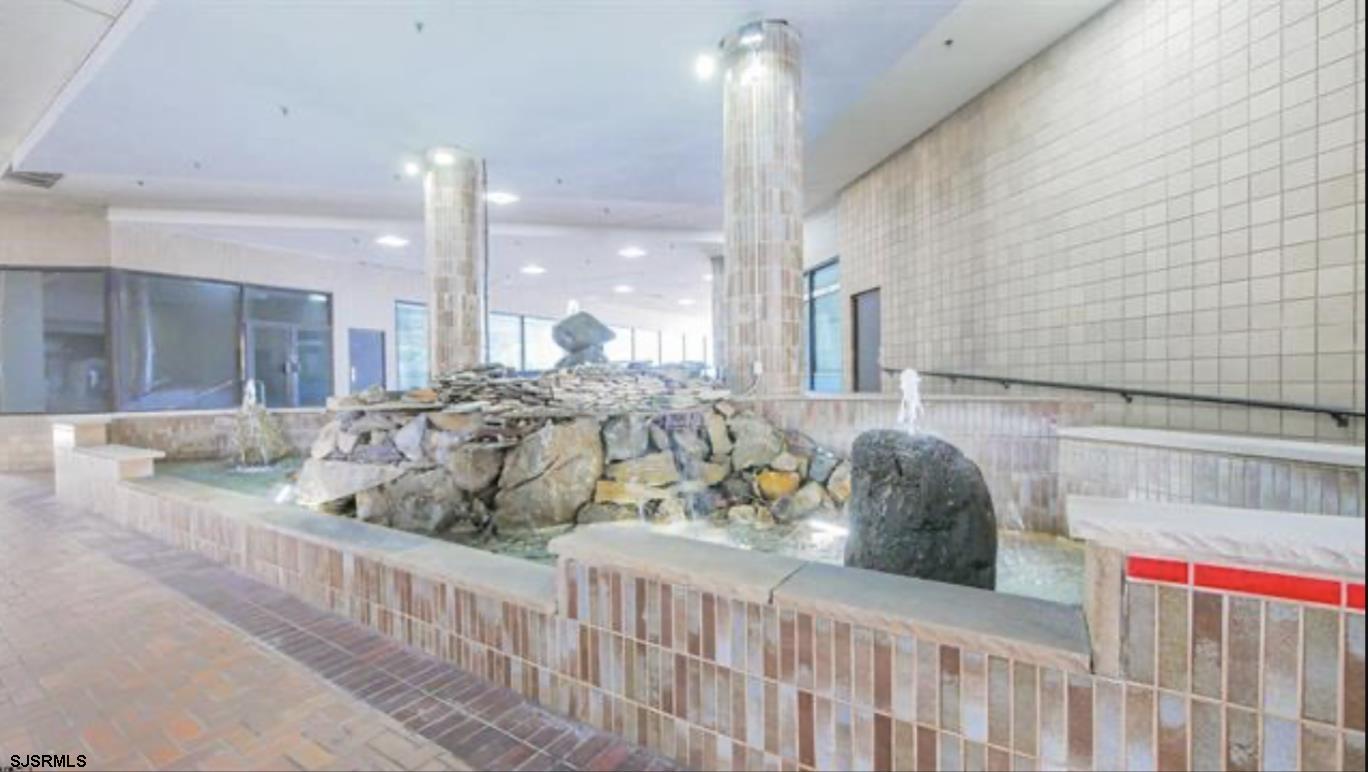 3101 Boardwalk, Unit 12102 Atlantic City, NJ 08401 - Photo 23 of 27 a bedroom with furniture and a large window