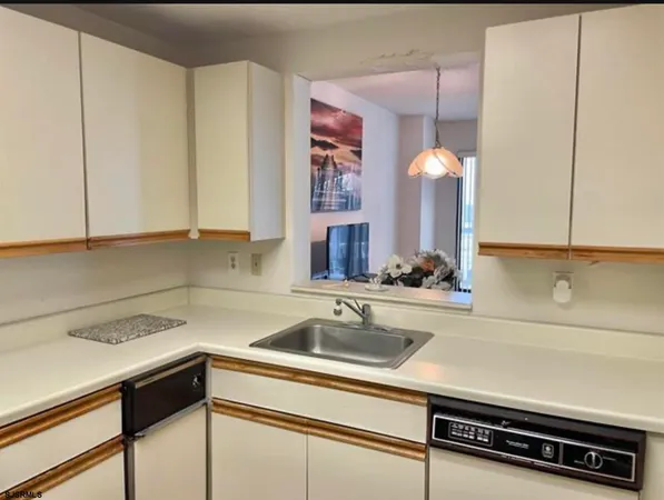 a kitchen with a sink cabinets and window