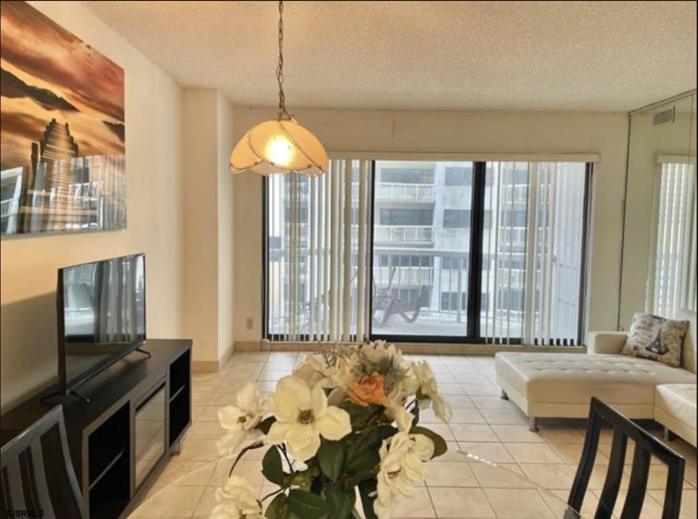 3101 Boardwalk, Unit 12102 Atlantic City, NJ 08401 - Photo 8 of 27 a spacious bedroom with a bed and a chandelier