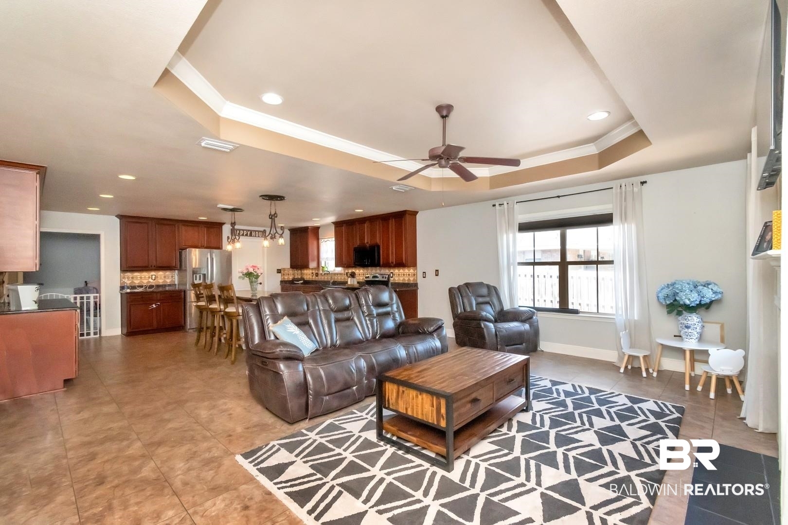 27890 Rileywood Drive Daphne, AL 36526 - Photo 20 of 49 Living area featuring a tray ceiling, light tile patterned flooring, visible vents, recessed lighting, and ceiling fan