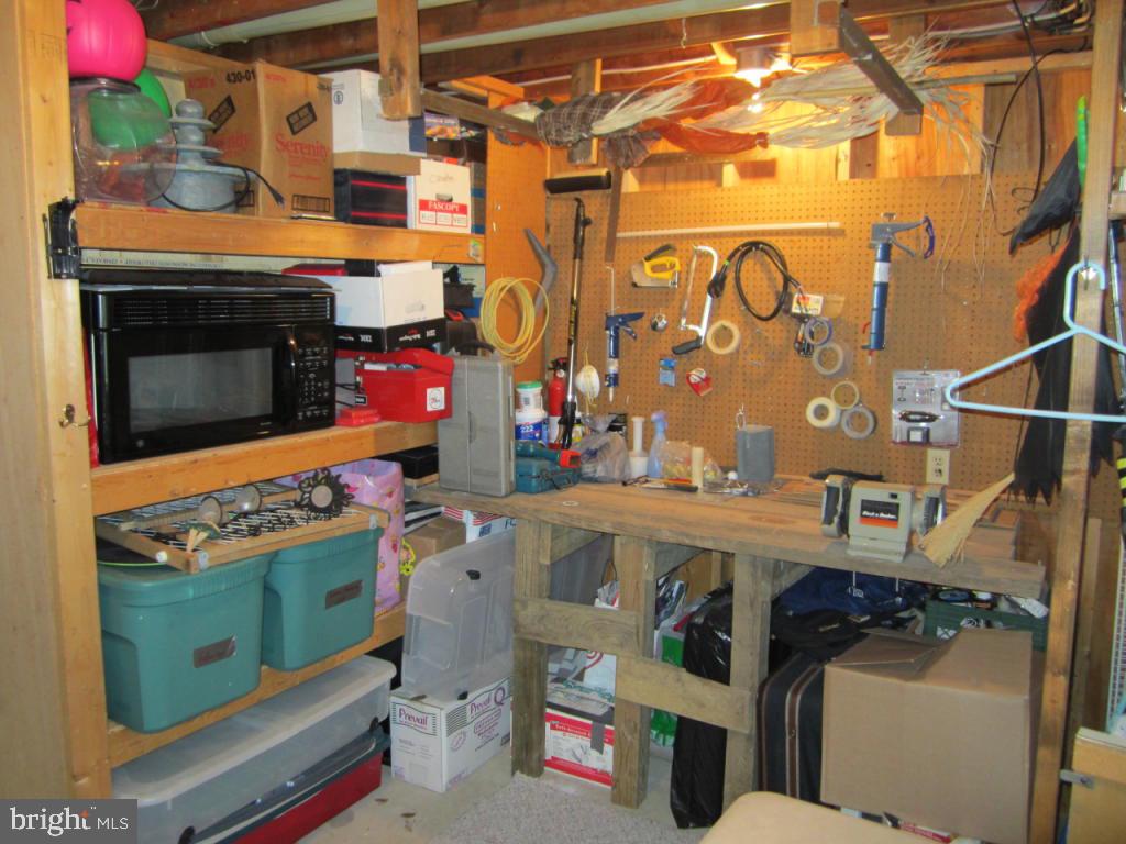 238 Hickory Drive Lititz, PA 17543 - Photo 26 of 27 a utility room with a fireplace a flat screen tv and a stove