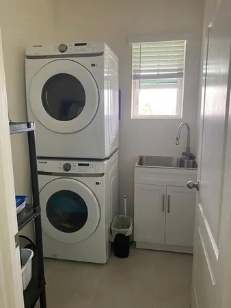 a utility room with sink dryer and washer