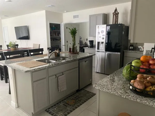 a kitchen with a sink and refrigerator