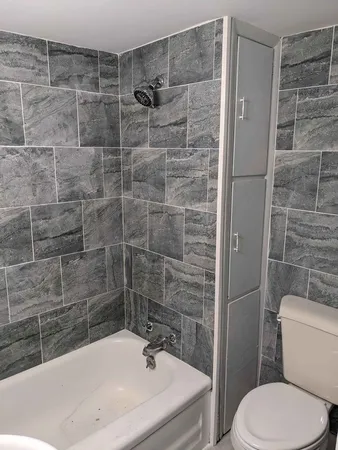 a bathroom with a sink toilet and shower