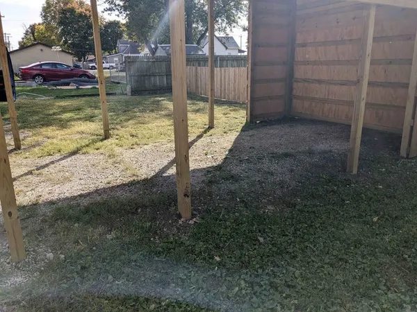 a view of a wooden deck with a yard