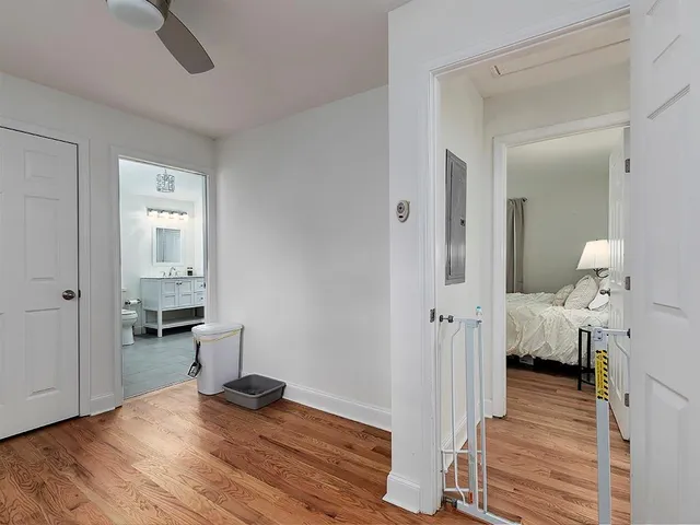 a view of a room with wooden floor and furniture