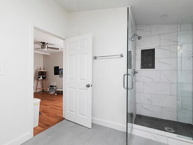 a bathroom with a shower and a glass door
