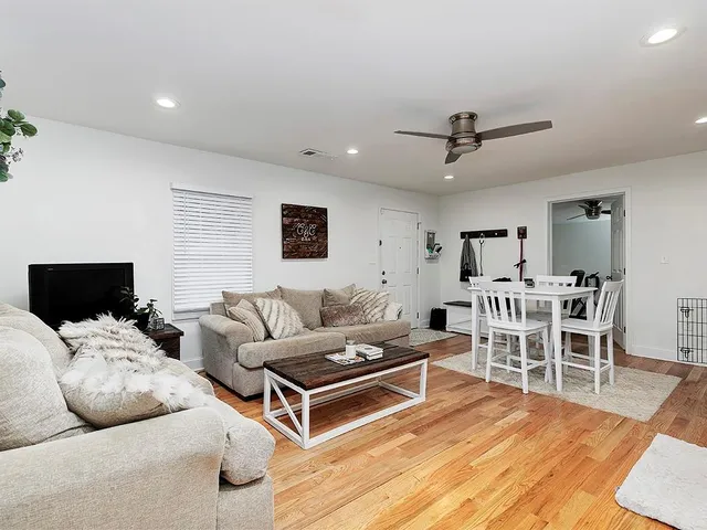 a living room with furniture and view of kitchen
