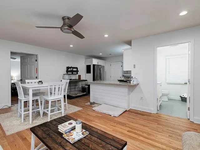 a kitchen with a sink table and chairs