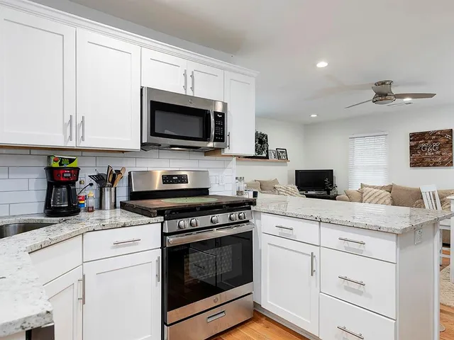 a kitchen with cabinets stainless steel appliances and a sink