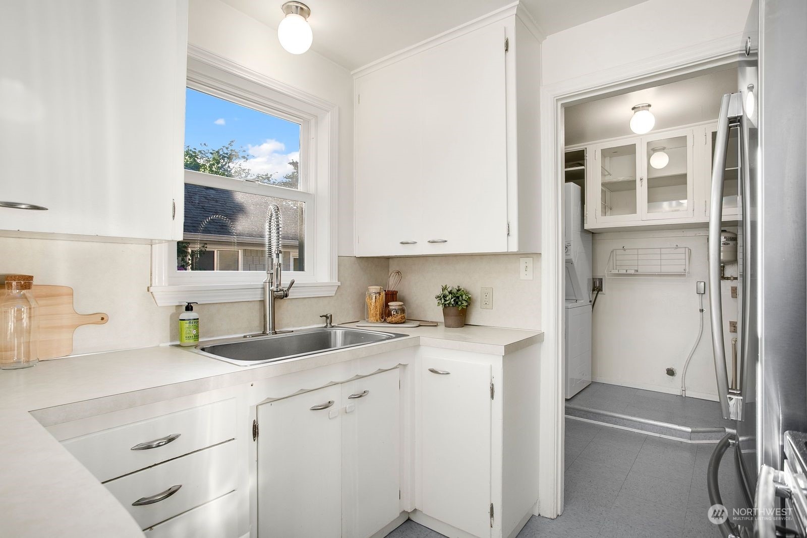 3702 Southwest Holden Street Seattle, WA 98126 - Photo 6 of 23 a kitchen with a sink cabinets and window