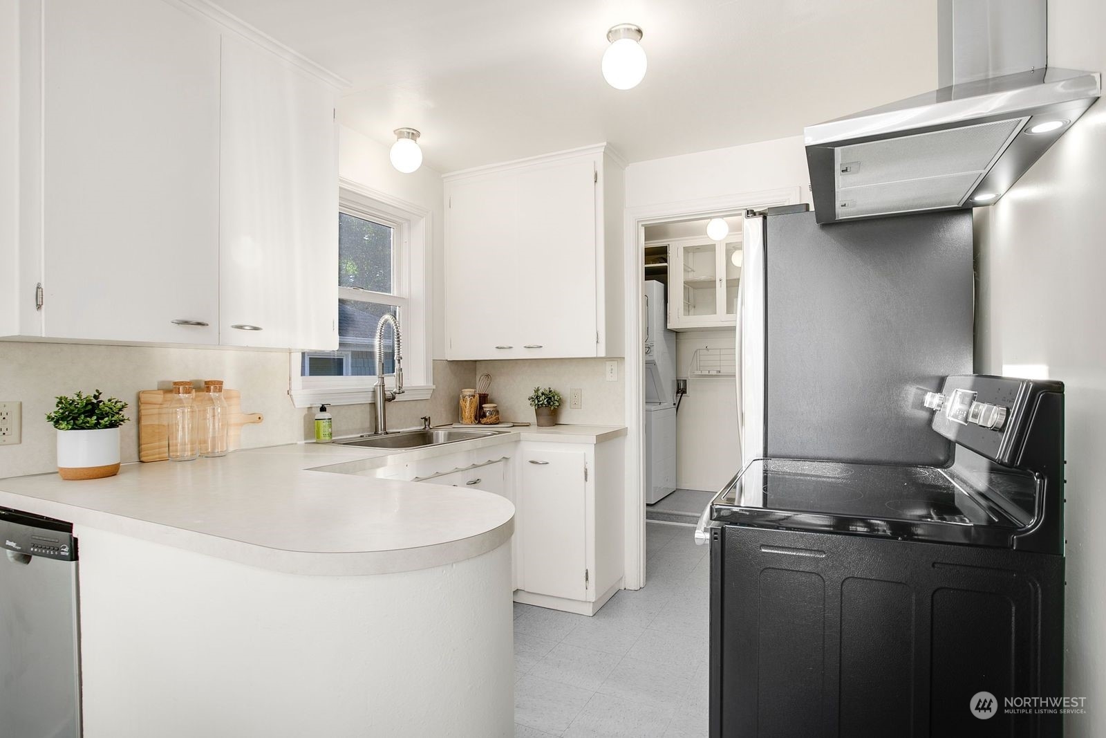 3702 Southwest Holden Street Seattle, WA 98126 - Photo 7 of 23 a kitchen with stainless steel appliances granite countertop a sink stove and refrigerator