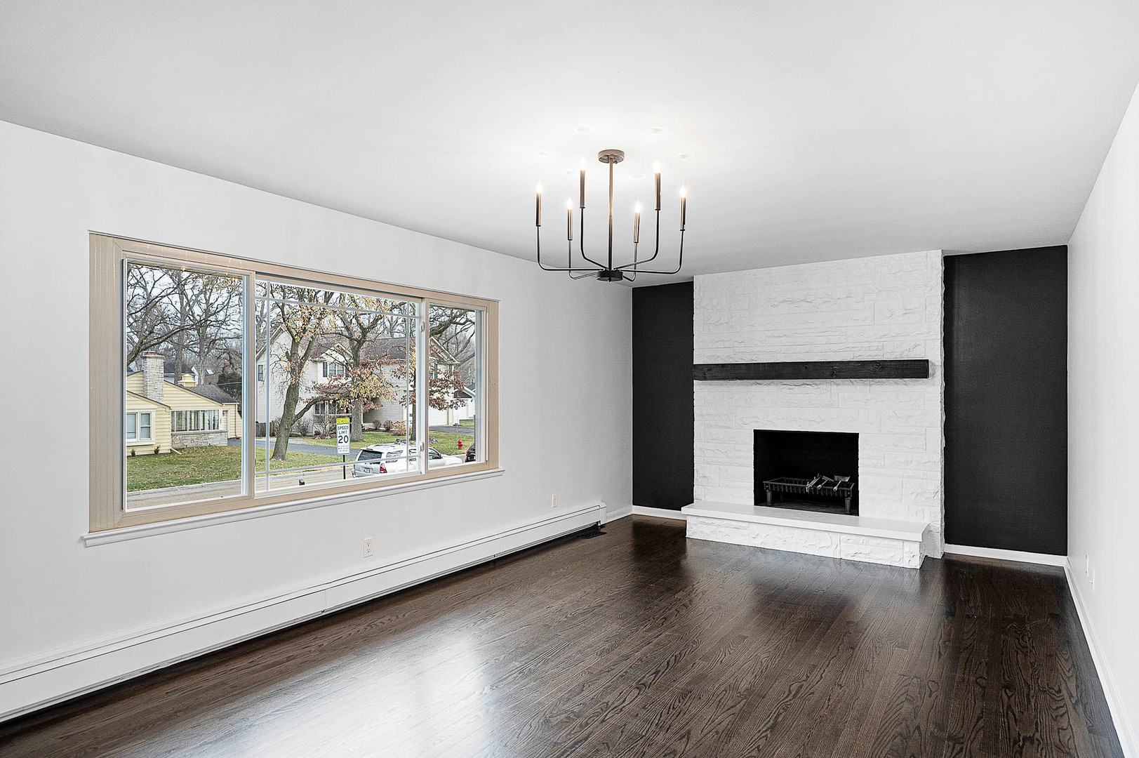 520 Dodson Street Geneva, IL 60134 - Photo 4 of 21 a view of empty room with wooden floor fireplace and window