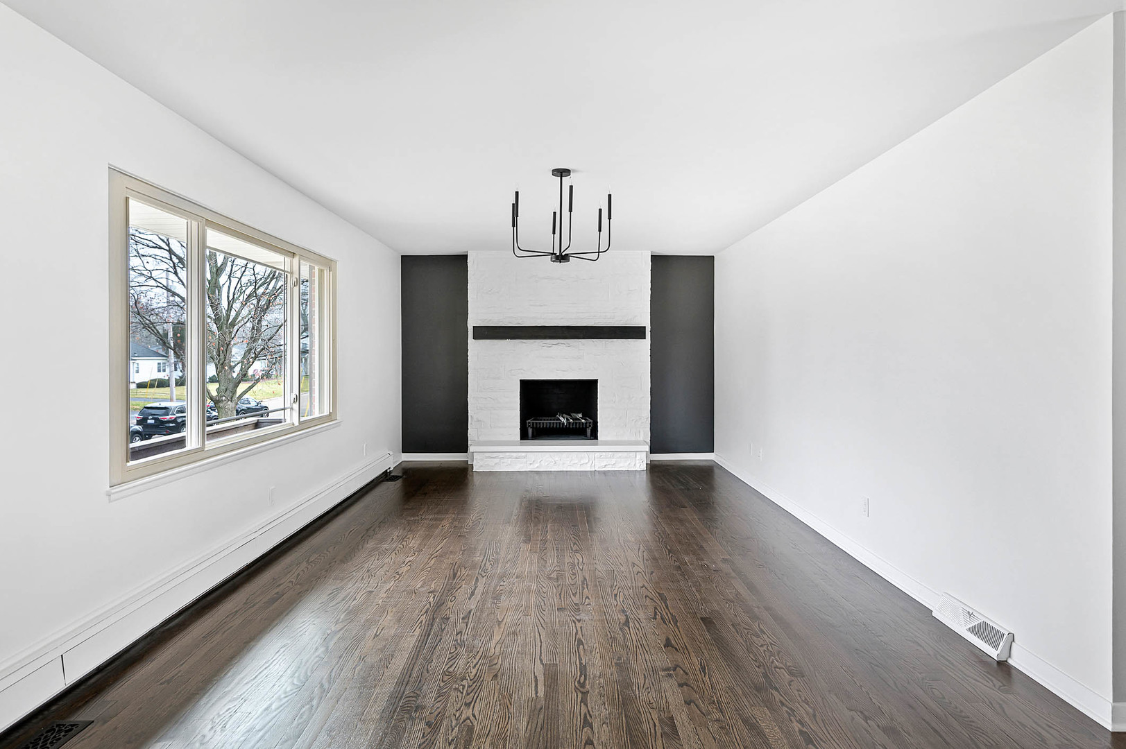 520 Dodson Street Geneva, IL 60134 - Photo 5 of 21 an empty room with wooden floor fireplace and windows