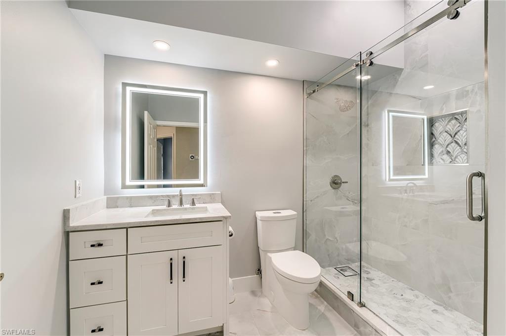 10751 Crooked River Road, Unit 202 Estero, FL 34135 - Photo 24 of 45 LIGHTED MIRRORBARN DOOR SHOWER DOOR