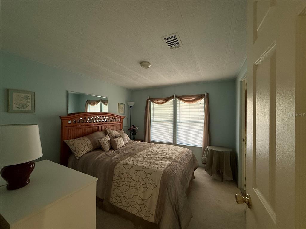 105 Cypress Road Wildwood, FL 34785 - Photo 15 of 26 a bedroom with two beds and a large window