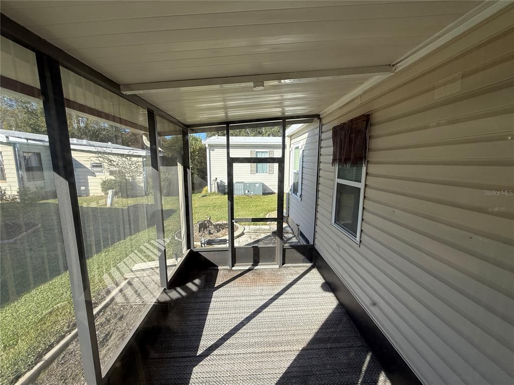 105 Cypress Road Wildwood, FL 34785 - Photo 22 of 26 a balcony with wooden floor and outdoor space