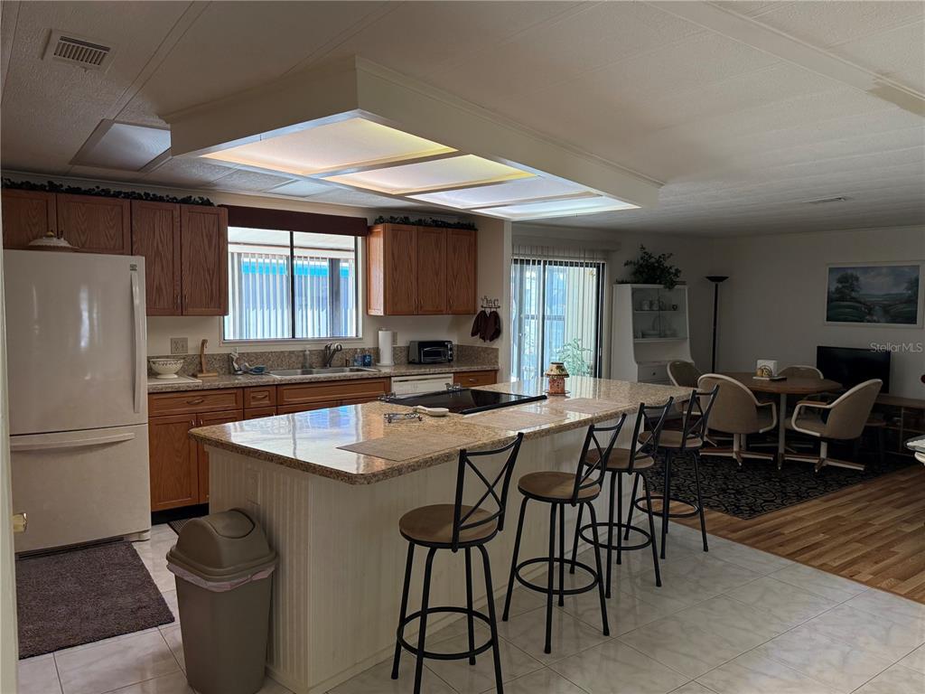 105 Cypress Road Wildwood, FL 34785 - Photo 3 of 26 a kitchen with center island table and chairs