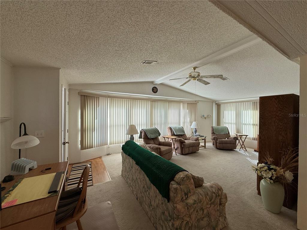 105 Cypress Road Wildwood, FL 34785 - Photo 10 of 26 a living room with furniture and a flat screen tv