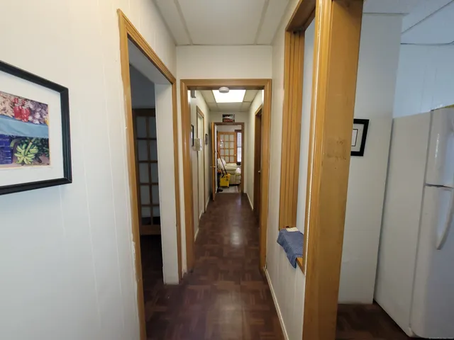 a view of hallway with wooden floor