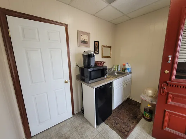 a kitchen with a sink and a stove top oven