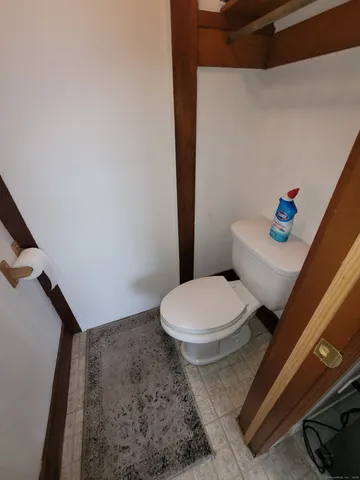 a white toilet sitting next to a bath tub