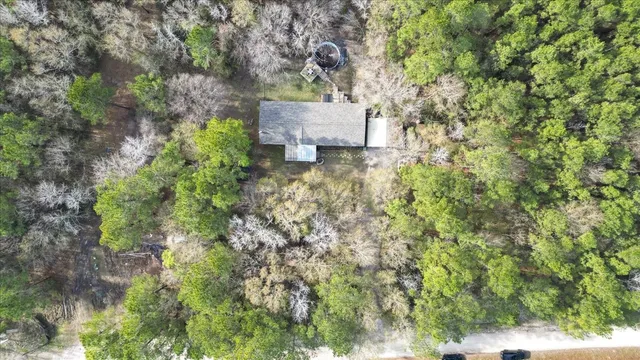 an aerial view of a house with a yard
