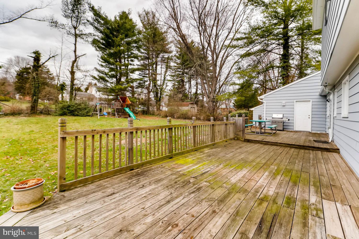 342 Old Joppa Road Fallston, MD 21047 - Photo 22 of 28 a view of a wooden deck and lake with trees in the background