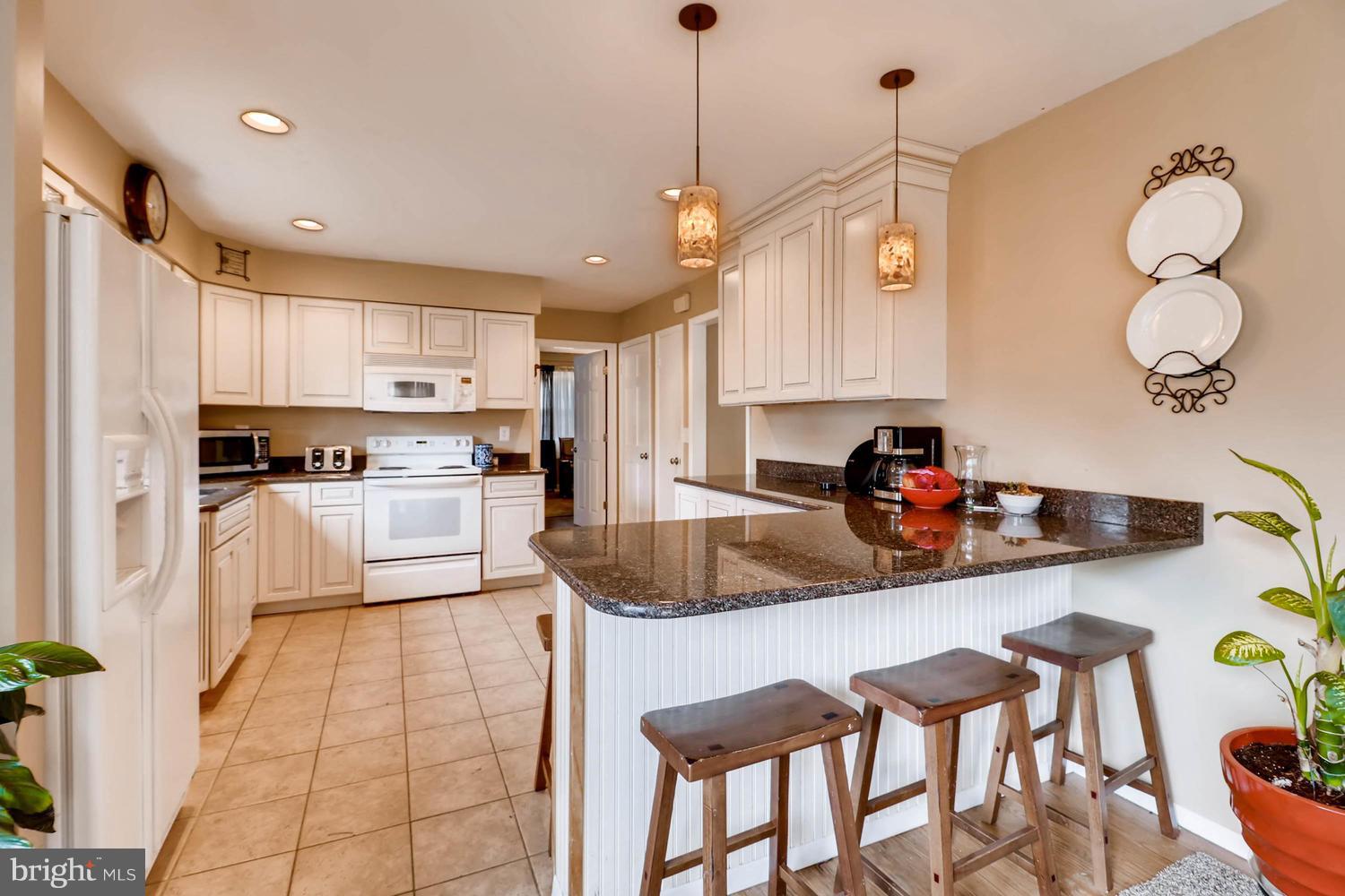 342 Old Joppa Road Fallston, MD 21047 - Photo 6 of 28 a kitchen with stainless steel appliances granite countertop a sink a stove and chairs