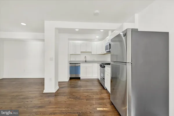 a kitchen with stainless steel appliances a refrigerator and a stove top oven