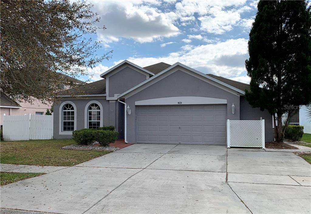1631 Open Field Loop Brandon, FL 33510 - Photo 1 of 1 a front view of a house with a garden
