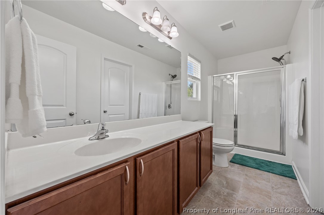 226 River Oak Street Spring Lake, NC 28390 - Photo 27 of 41 a bathroom with a sink double vanity shower and a mirror