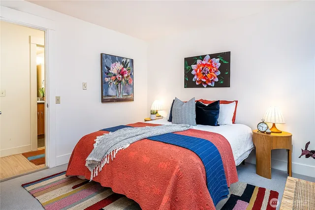 a bedroom with bed and wooden floor