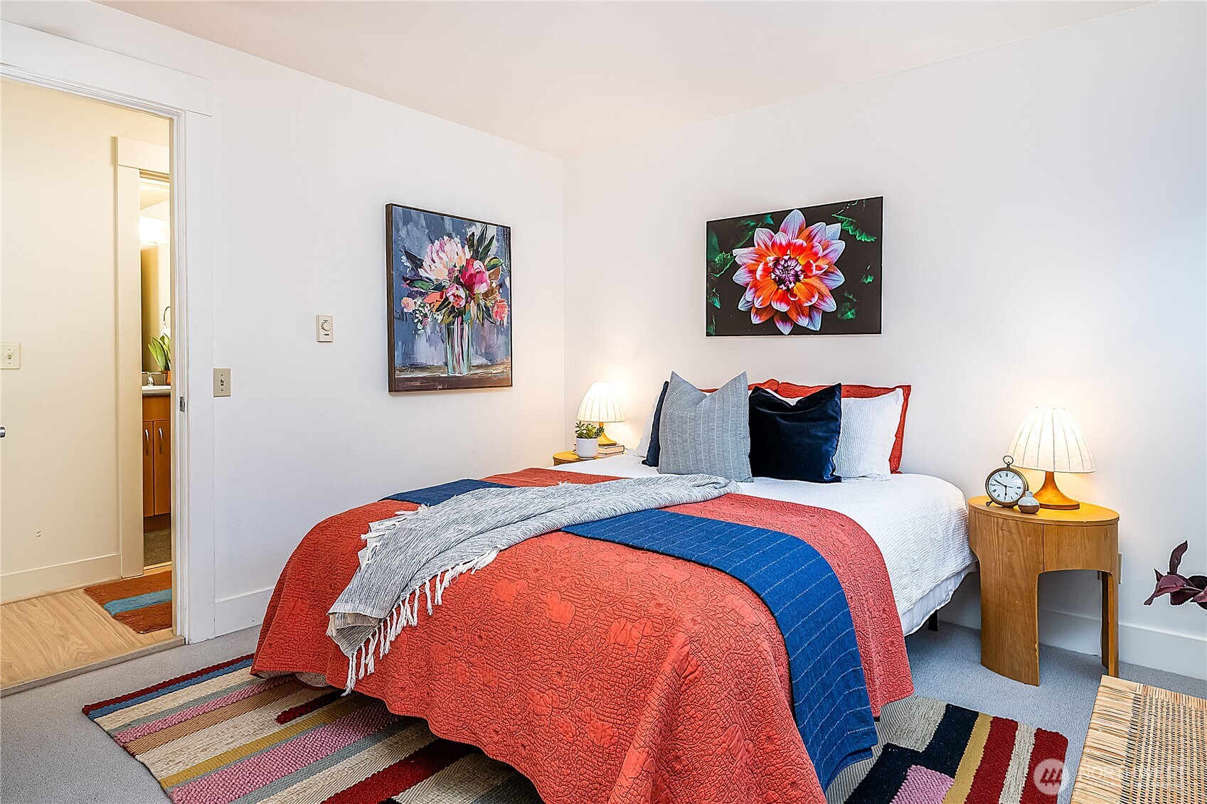 23015 Edmonds Way, Unit A214 Edmonds, WA 98020 - Photo 14 of 24 a bedroom with bed and wooden floor