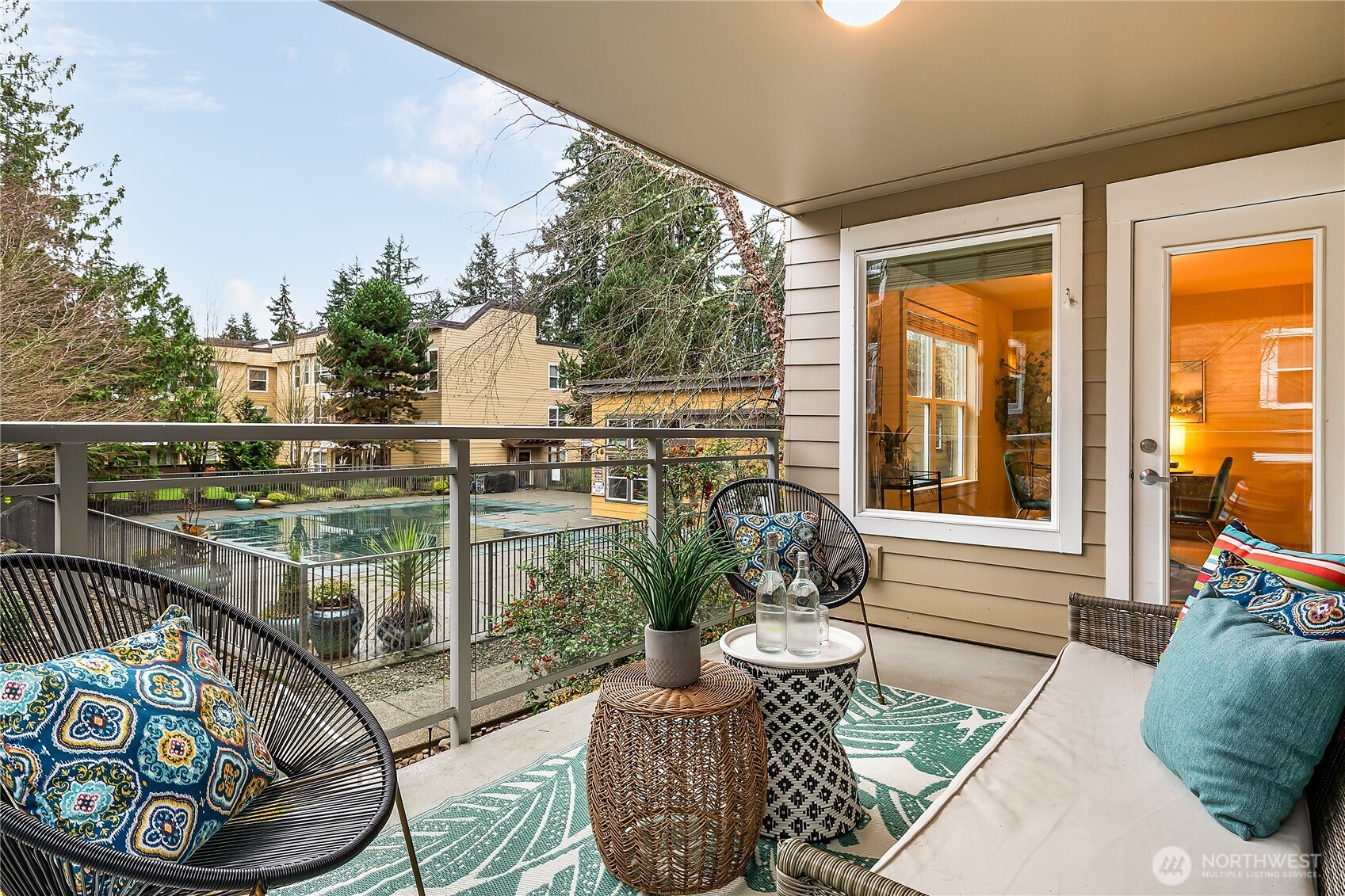 23015 Edmonds Way, Unit A214 Edmonds, WA 98020 - Photo 16 of 24 a view of a balcony with chairs and iron fence
